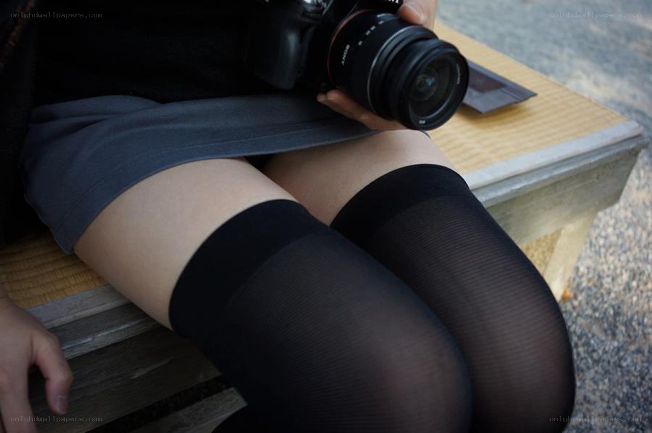 person holding camera on bench