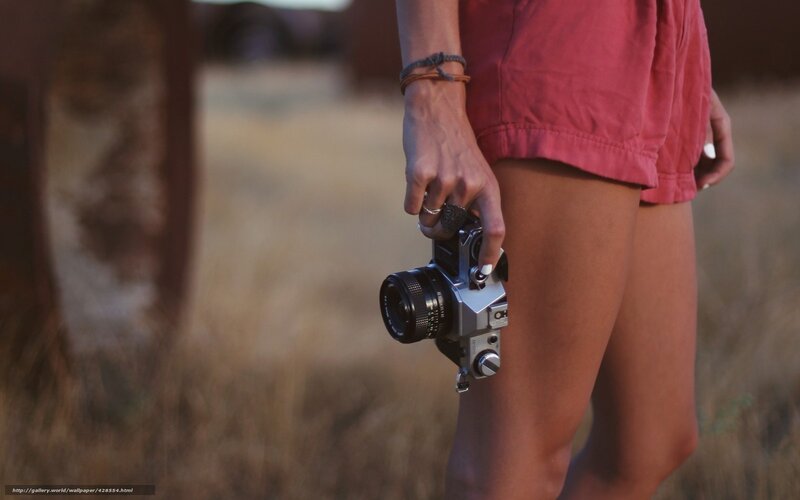 person holding camera outdoors