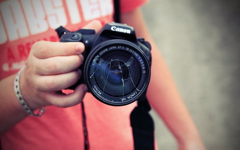 Person Holding Camera — Red, Neutral, Photograph