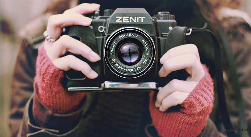 Person Holding Camera — Sweater