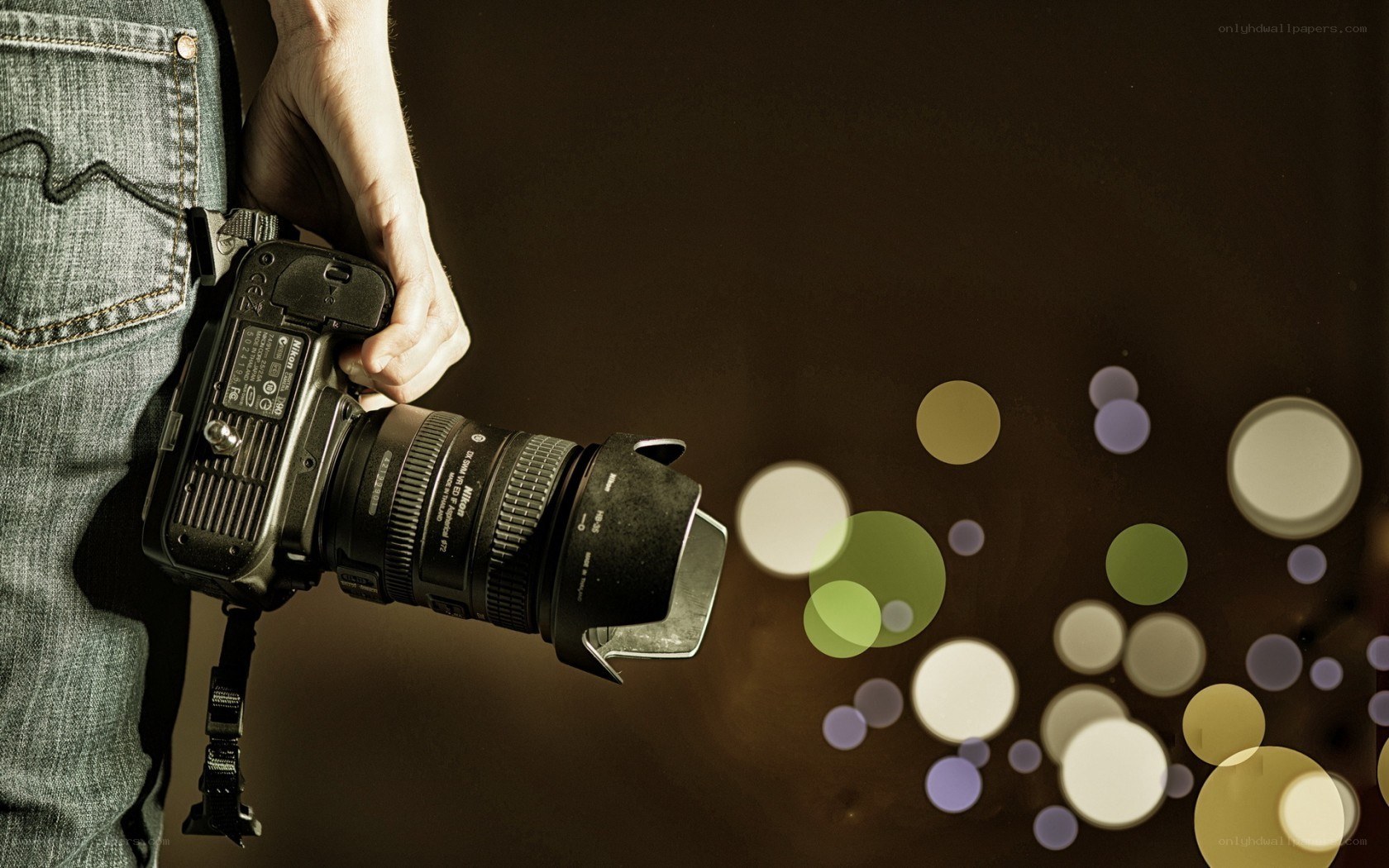 person holding camera with bokeh
