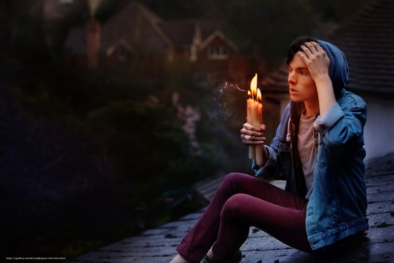 person holding candles on roof