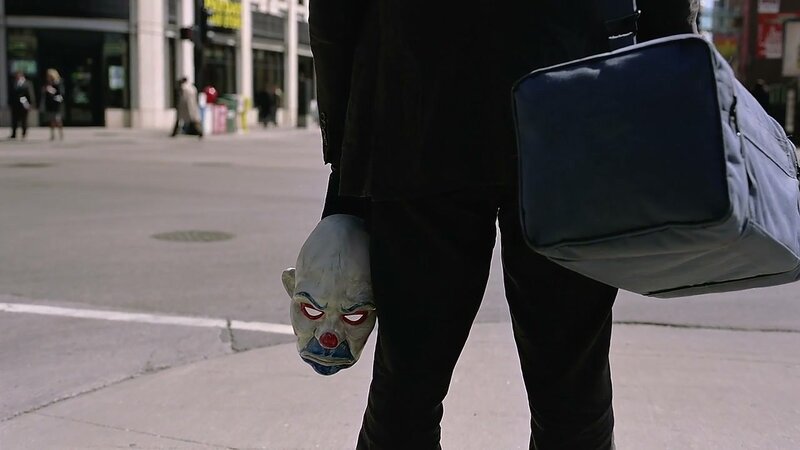 person holding clown mask