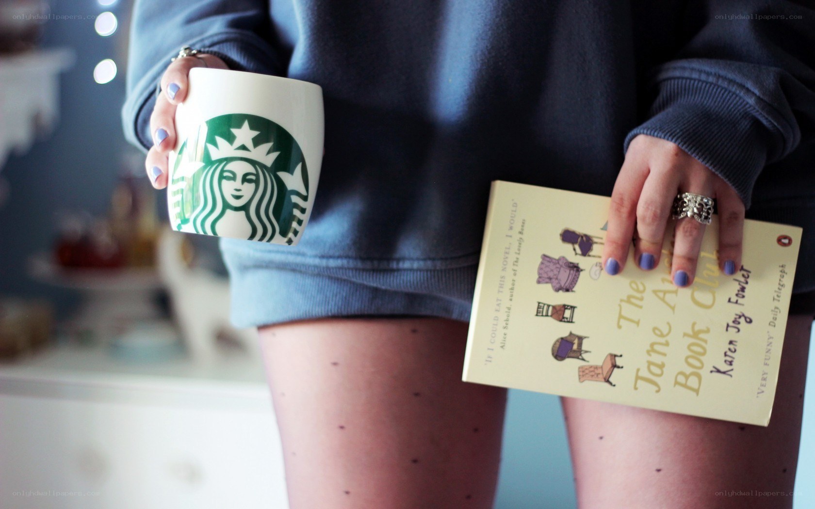 person holding coffee and book