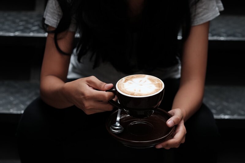 Person Holding Coffee Cup — Black