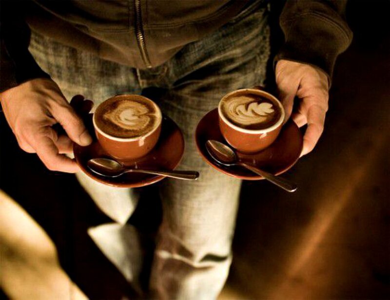 Person Holding Coffee Cups