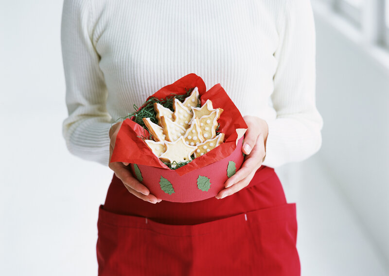 person holding cookies in a box