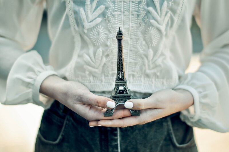 Person Holding Eiffel Tower Model