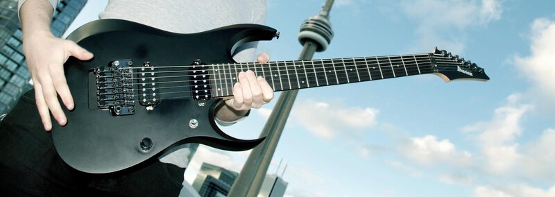 Person Holding Electric Guitar — Black, Outdoor