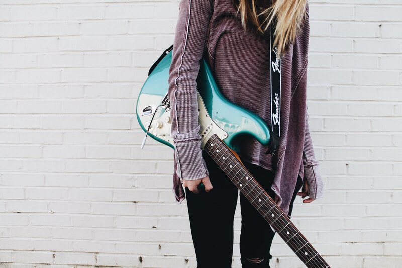 person holding electric guitar