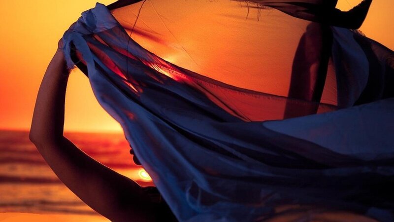 Person Holding Fabric — Orange
