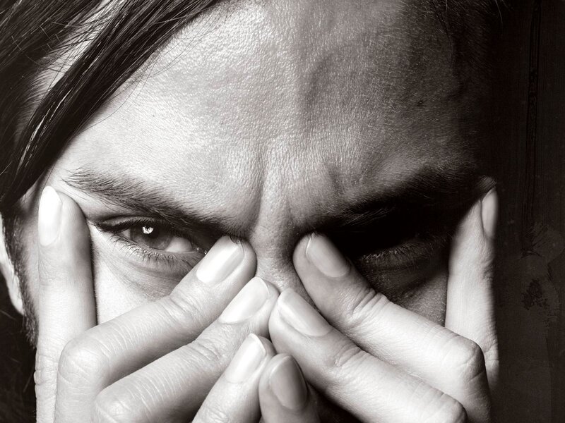 person holding face in hands