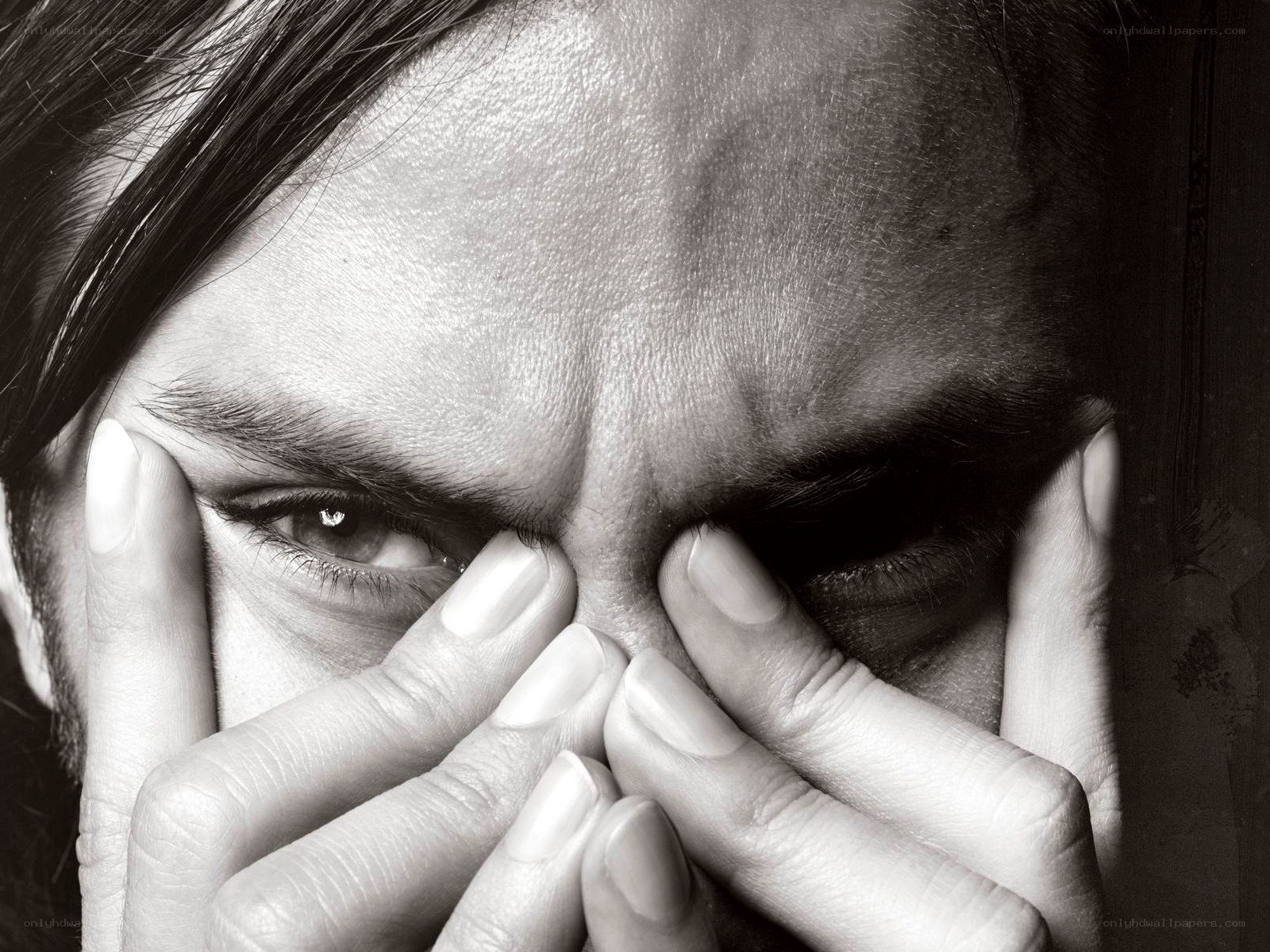 person holding face in hands