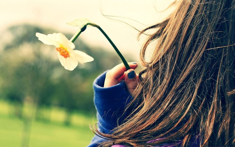 Person Holding Flower — Brown