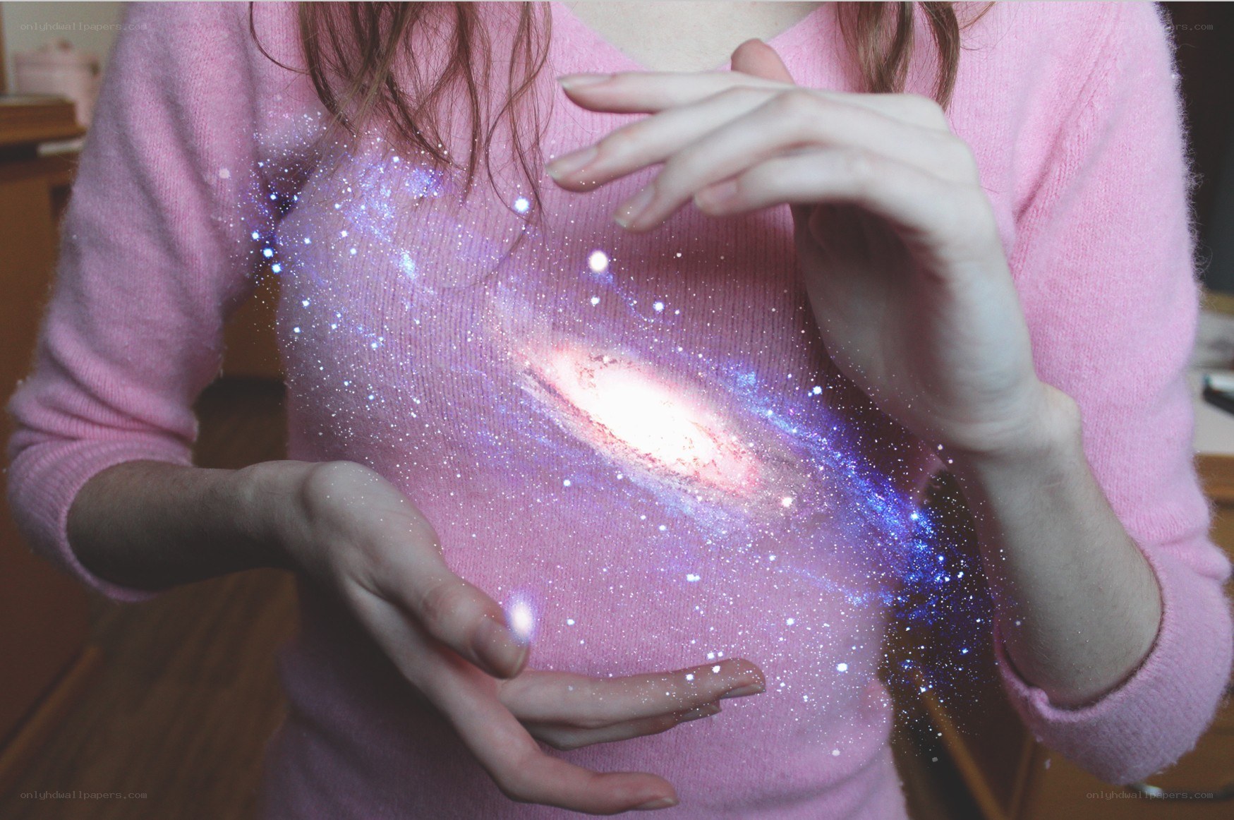 person holding galaxy in hands
