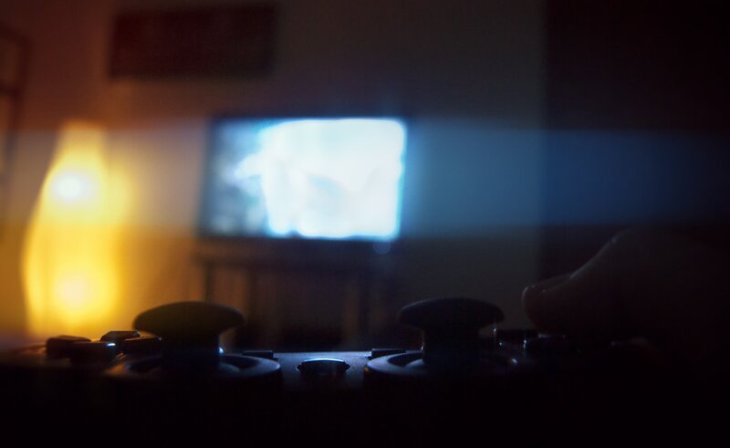 Person Holding Game Controller — Black, Dark