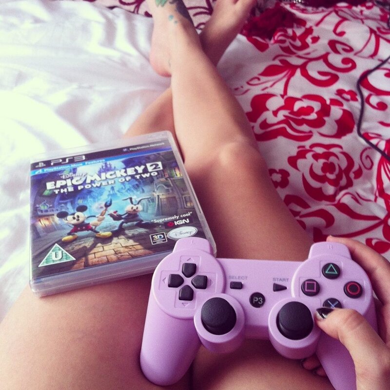 Person Holding Game Controller — Purple
