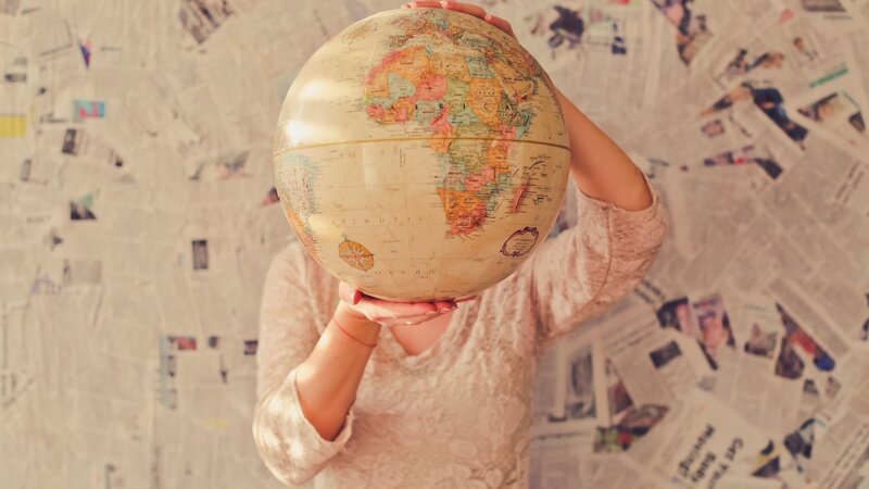 Person Holding Globe — Beige