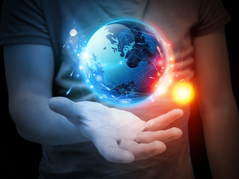 Person Holding Glowing Globe