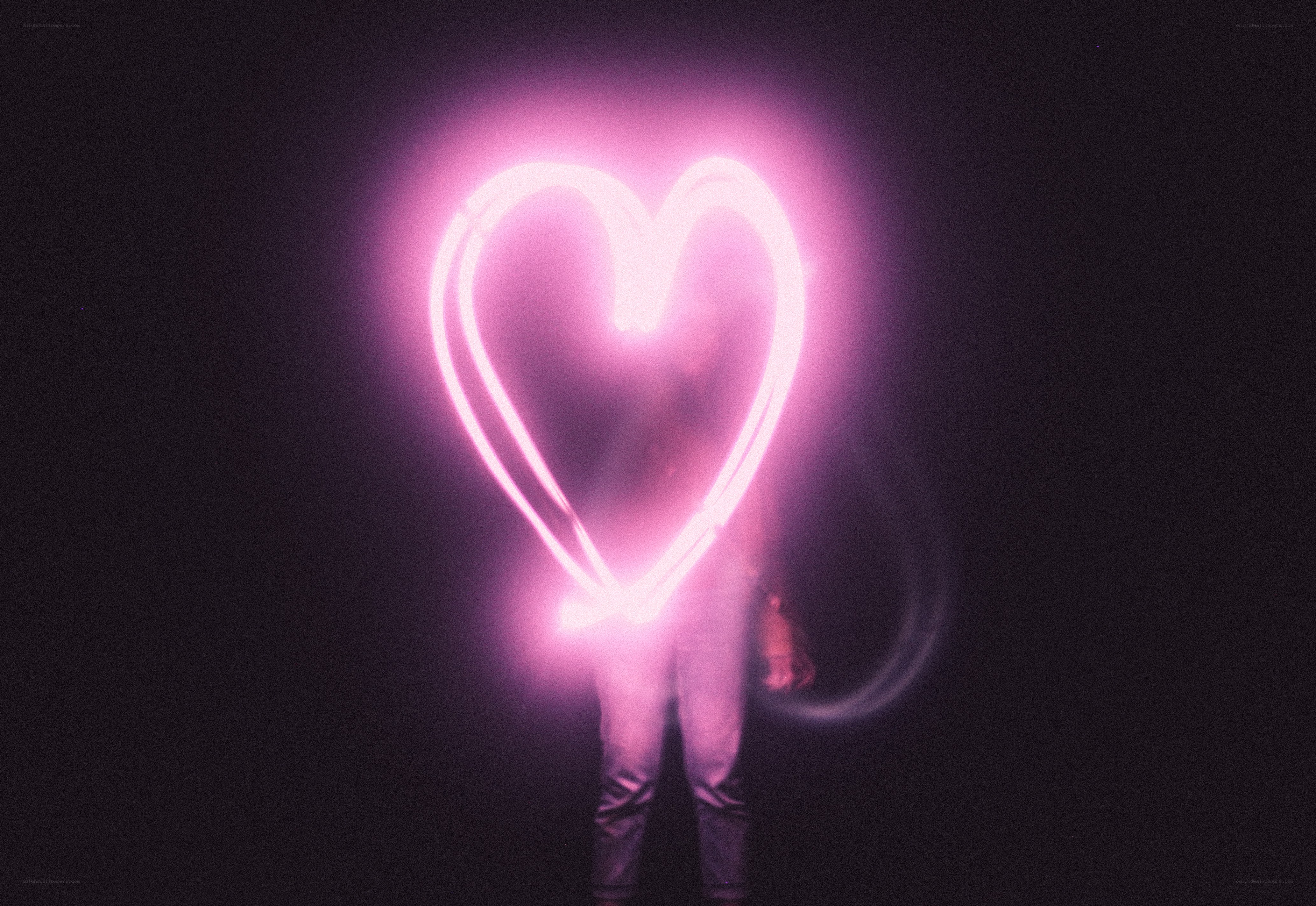 person holding glowing heart