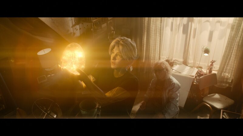 Person Holding Glowing Orb — Yellow