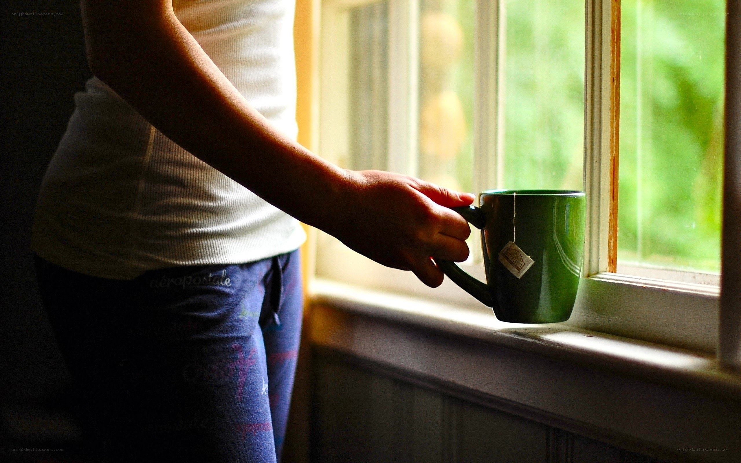 person holding green mug