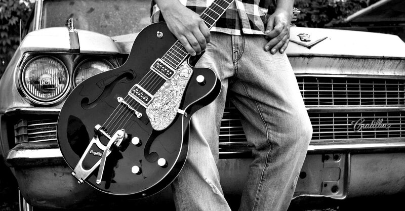 Person Holding Guitar — Black, Dramatic
