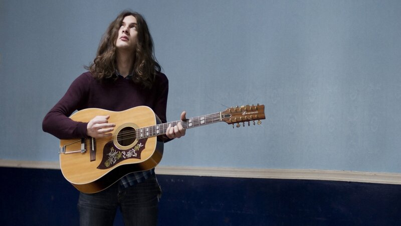 Person Holding Guitar — Blue