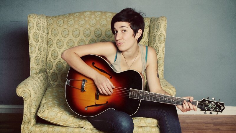 Person Holding Guitar — Brown
