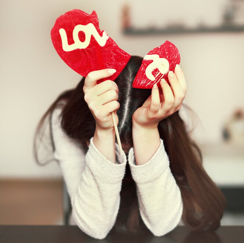 Person Holding Heart Lollipops