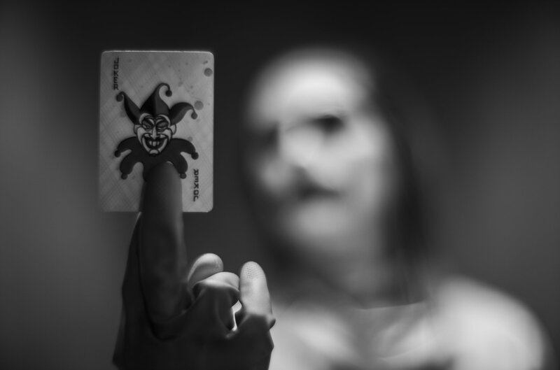 Person Holding Joker Card