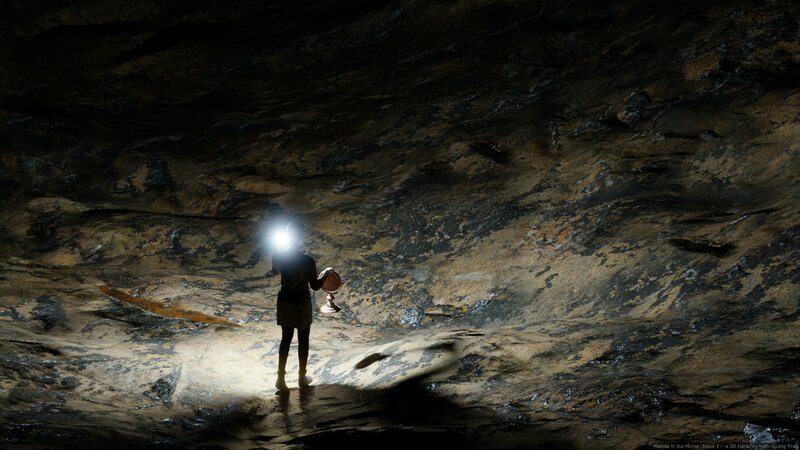 Person Holding Lantern in Cave