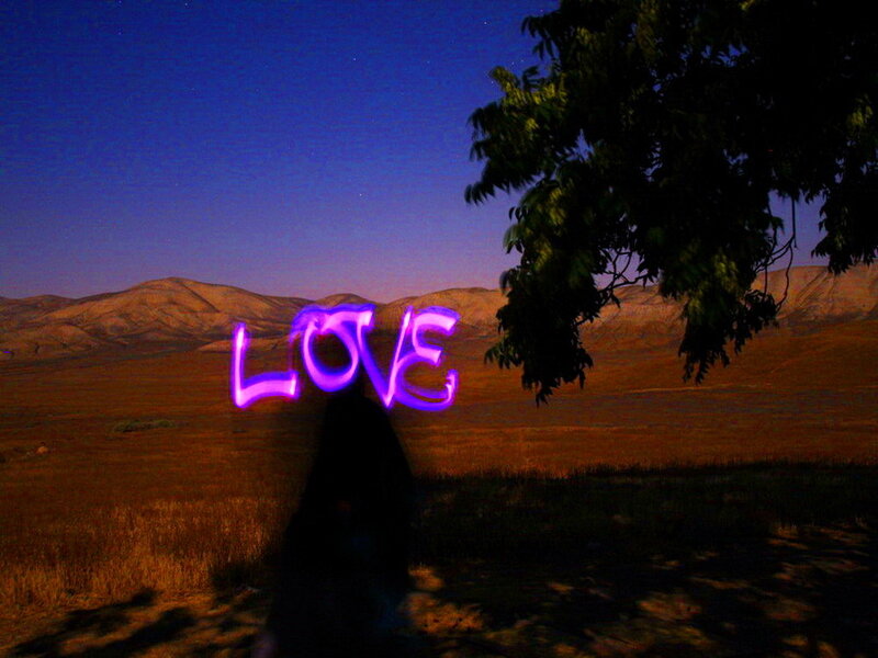 Person Holding Light Writing