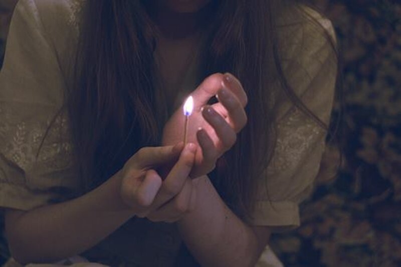 Person Holding Match