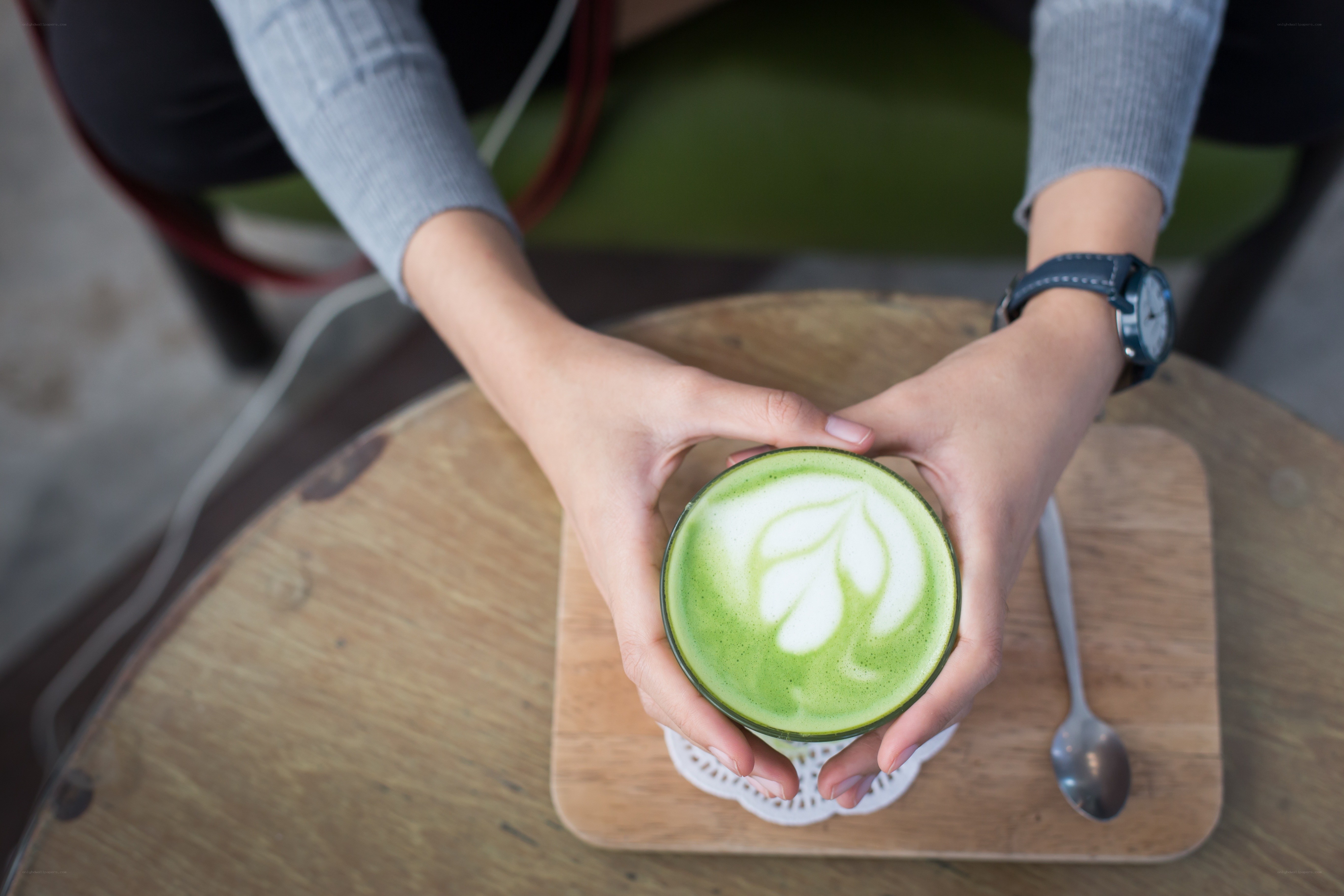 person holding matcha latte