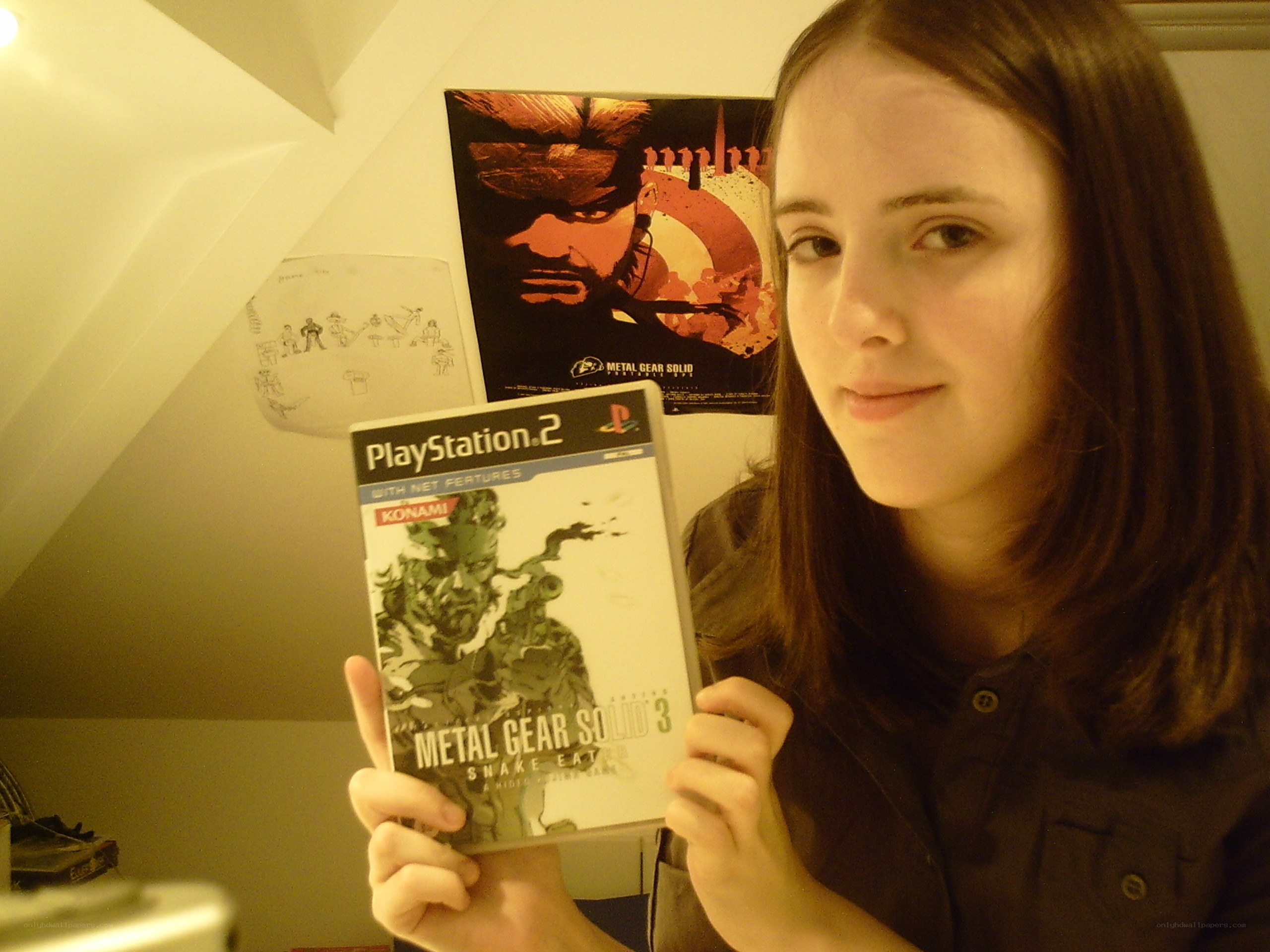 person holding metal gear solid 3 game