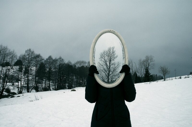 Person Holding Mirror — White, Dreary