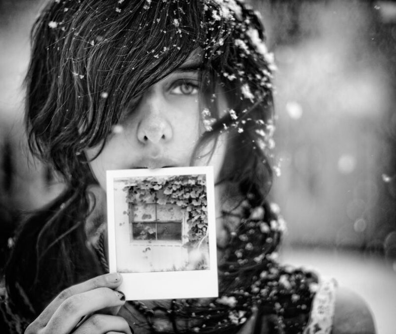 Person Holding Photo in Snow