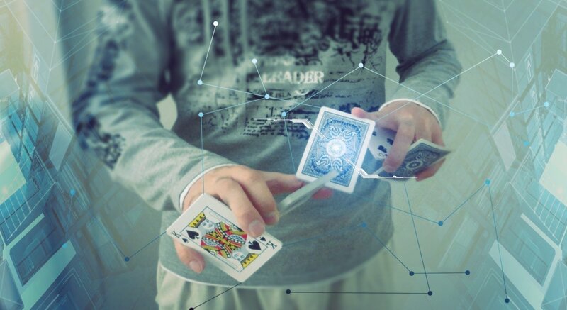 Person Holding Playing Cards — Blue