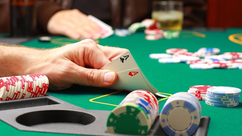 Person Holding Poker Cards