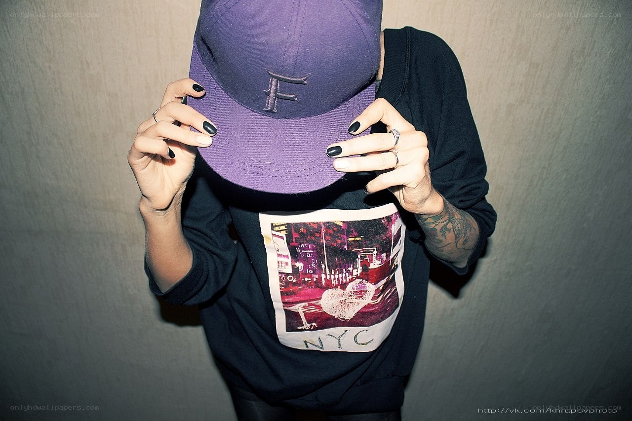 person holding purple cap