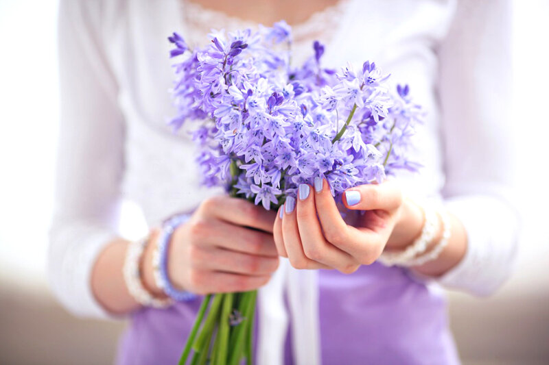 Person Holding Purple Flowers