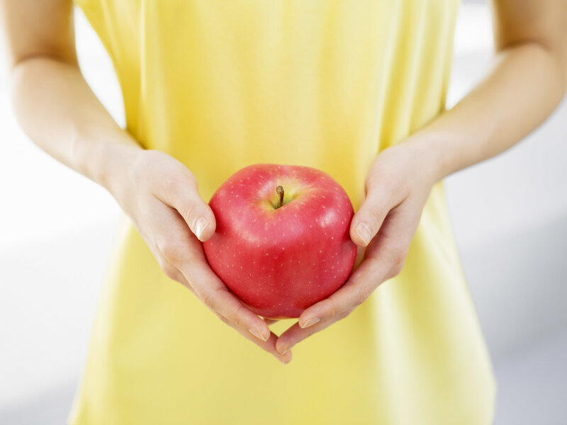 Person Holding Red Apple — Yellow