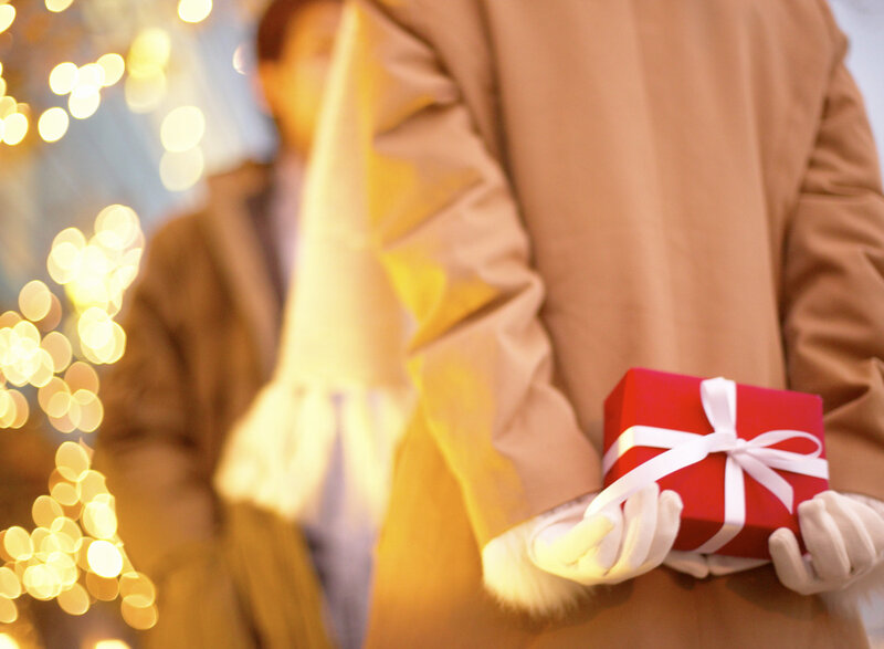 person holding red gift box