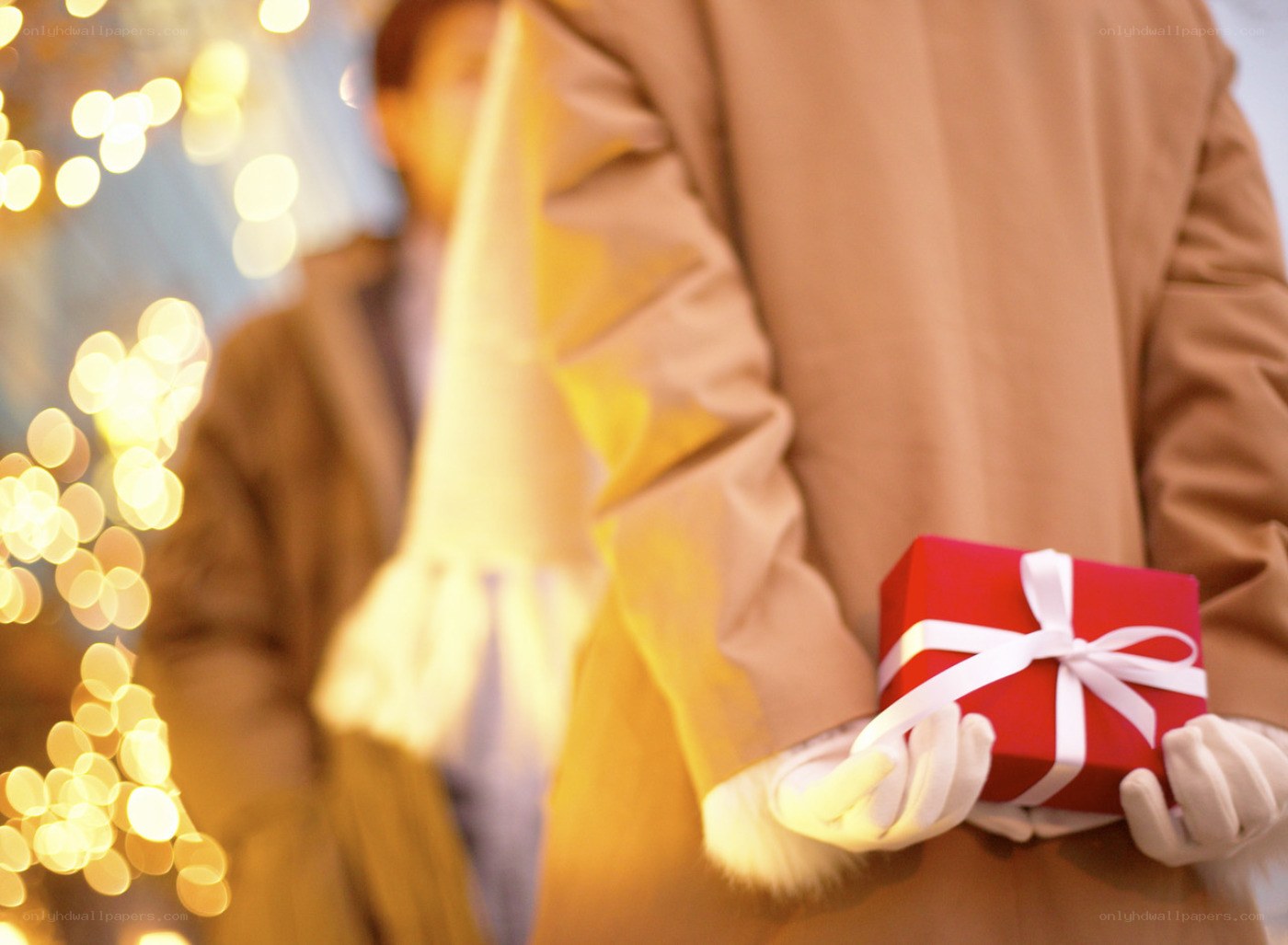 person holding red gift box