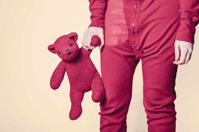 person holding red teddy bear