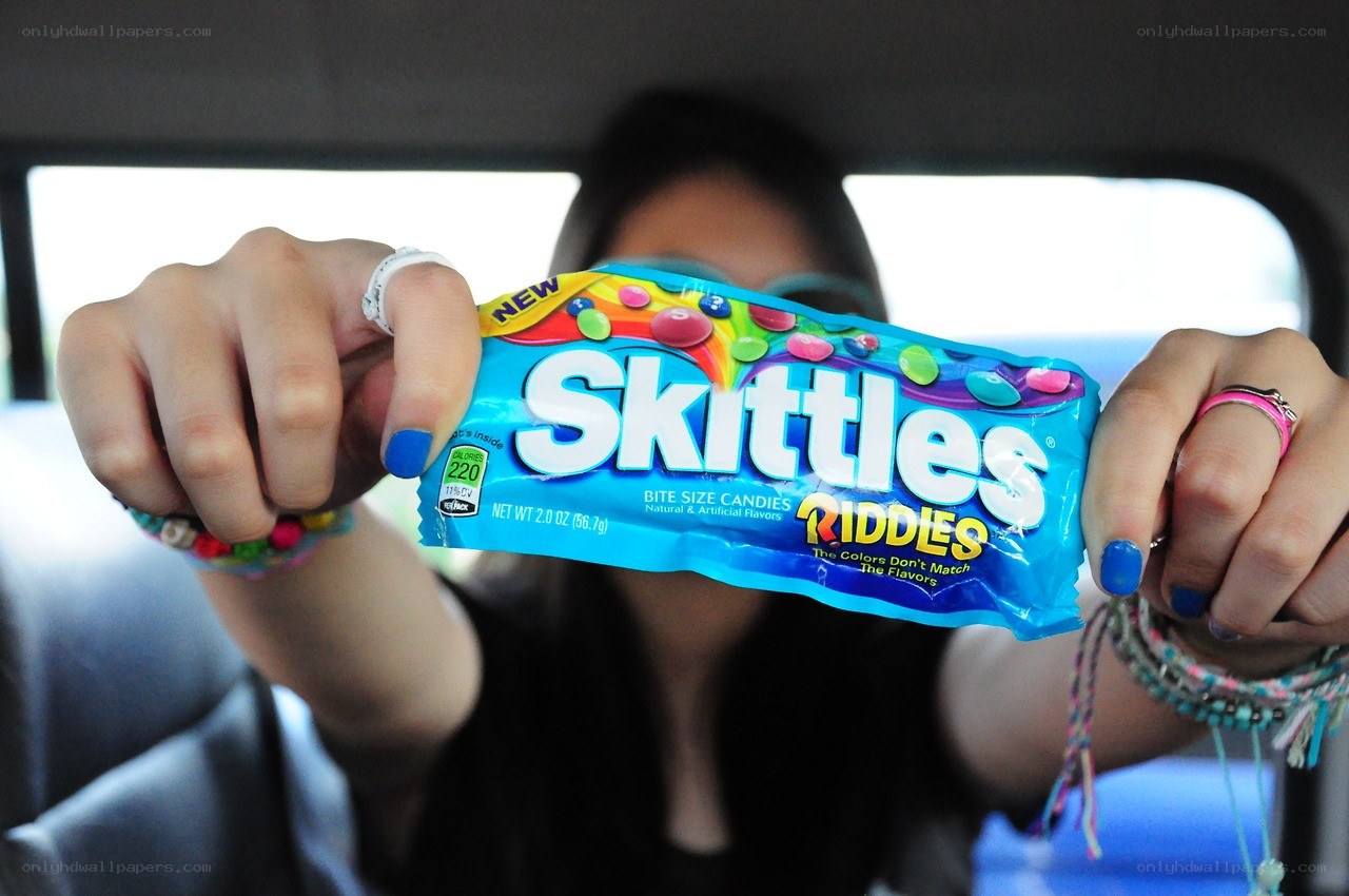 person holding skittles riddles