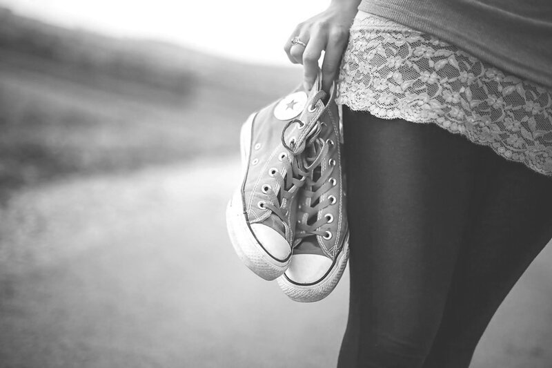 Person Holding Sneakers