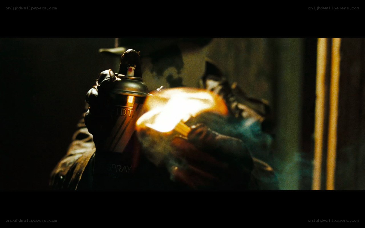 person holding spray can and flame