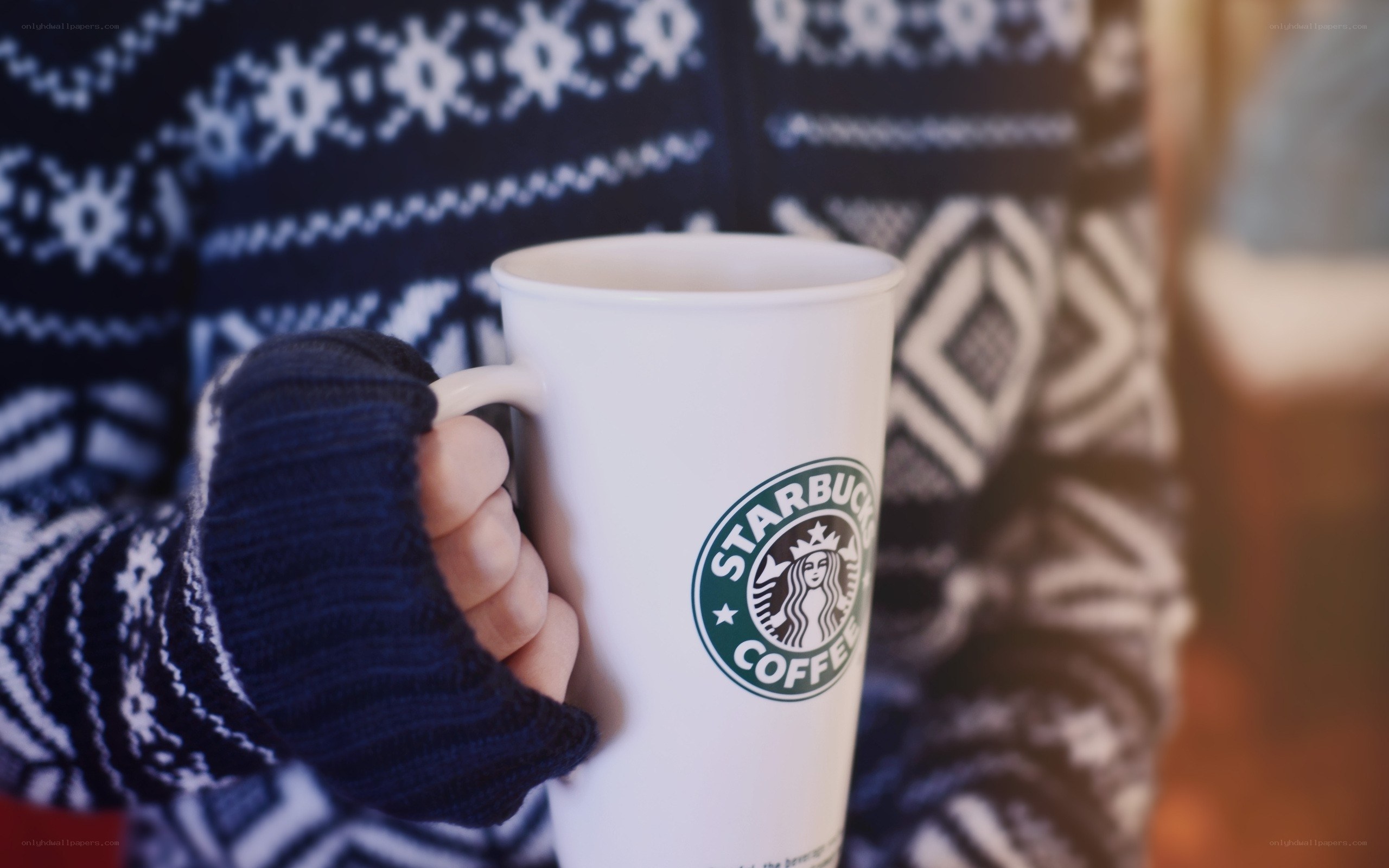 person holding starbucks cup